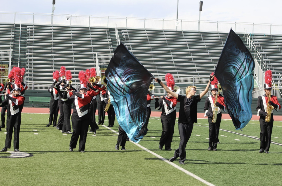 Color Guard section leader Robert Serrano takes the center of the field to show the beauty of “spreading his wings” as the ‘Black Swan’